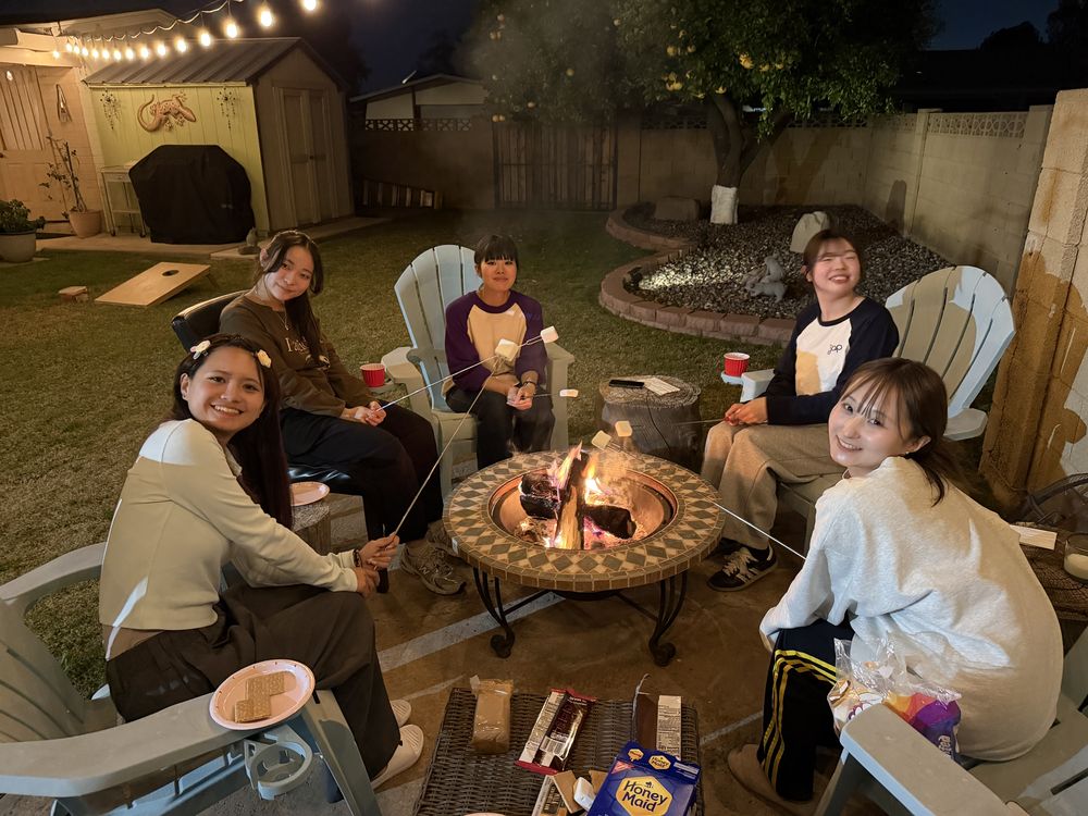 Students enjoying s'mores at host family firepit