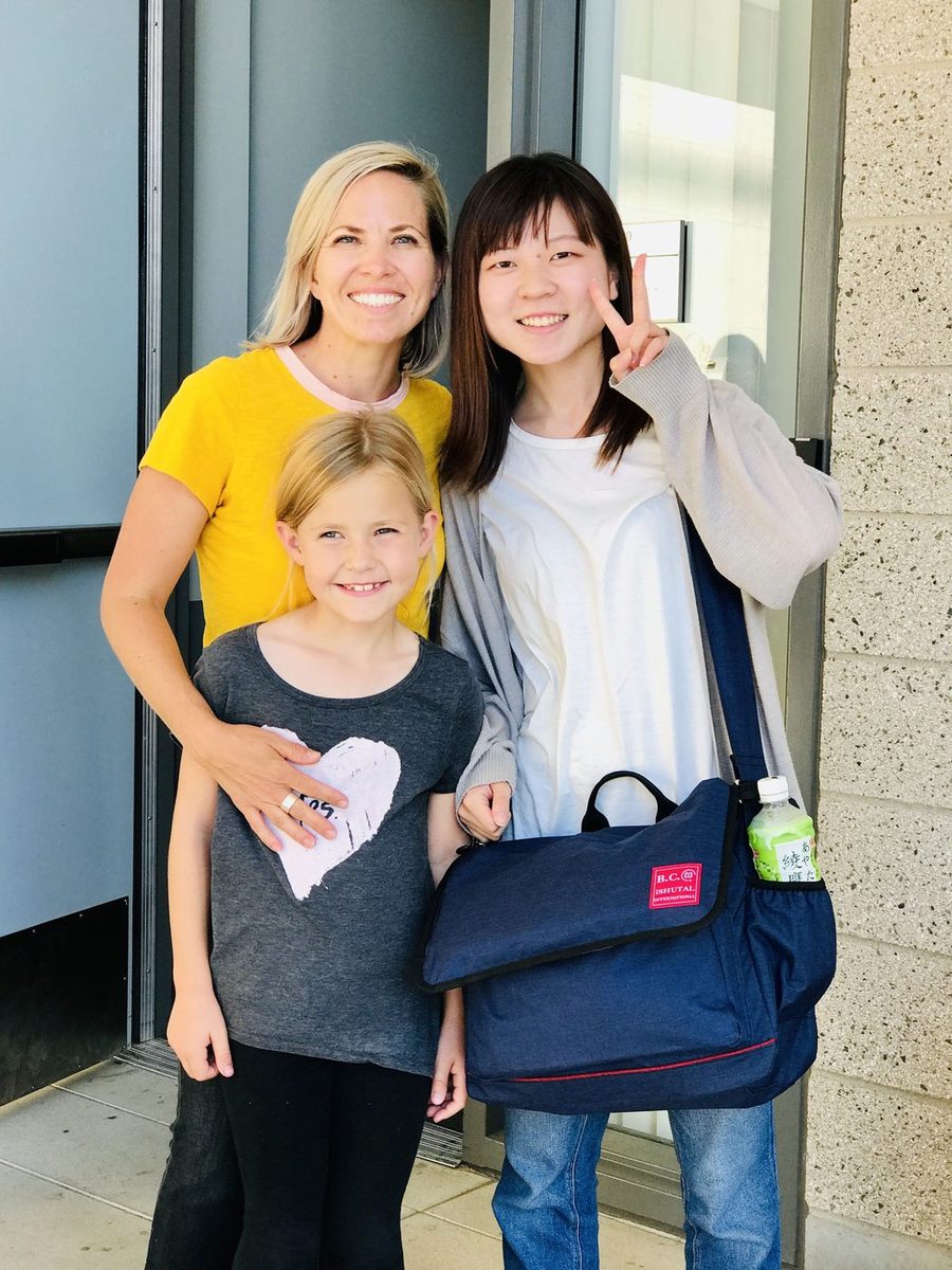 Host family welcoming student at their front door